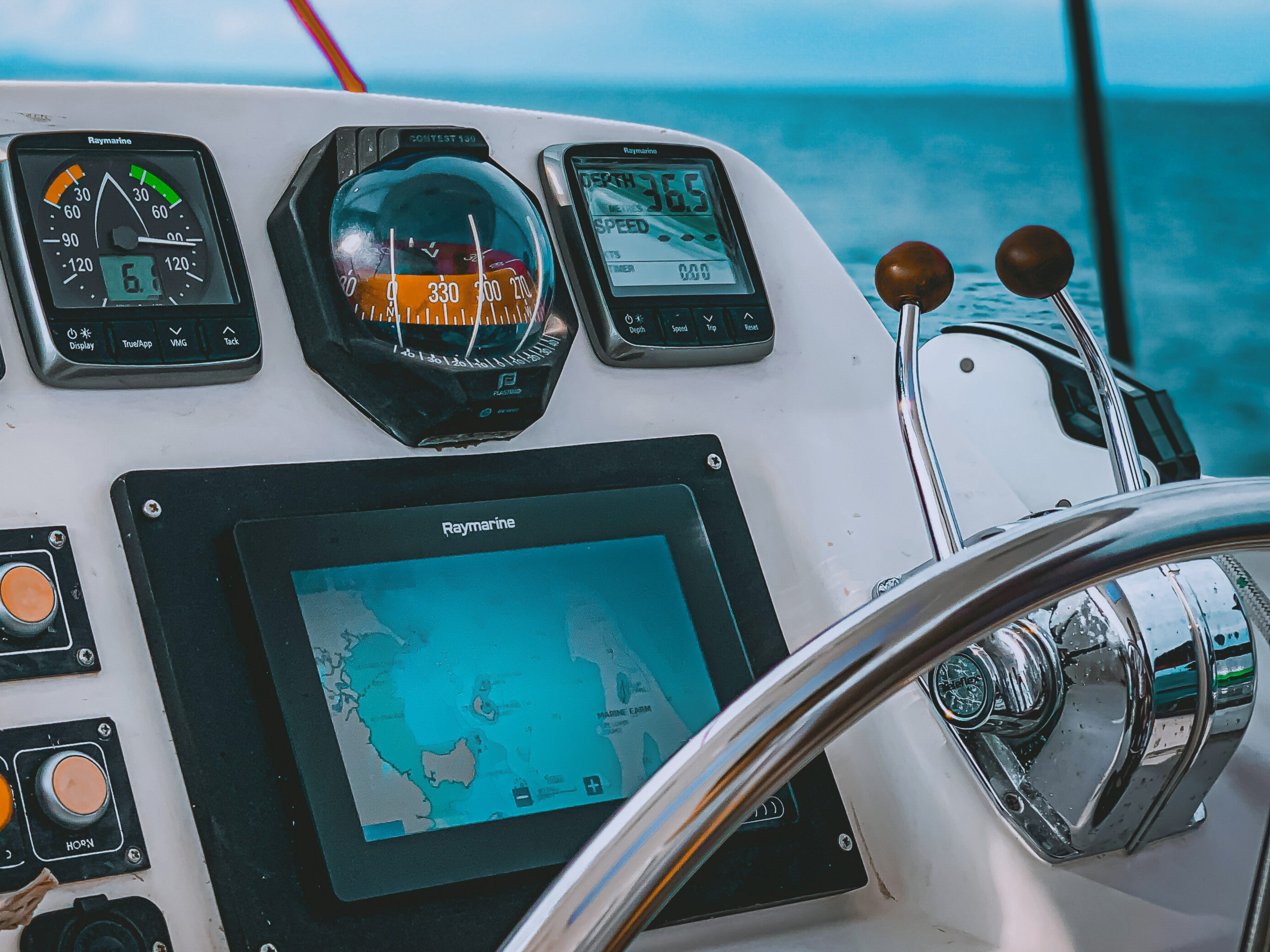 2. A boat equipped with a GPS and a steering wheel, highlighting essential tools for recreational power sports